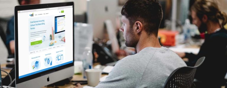 freshbooks on computer with man working